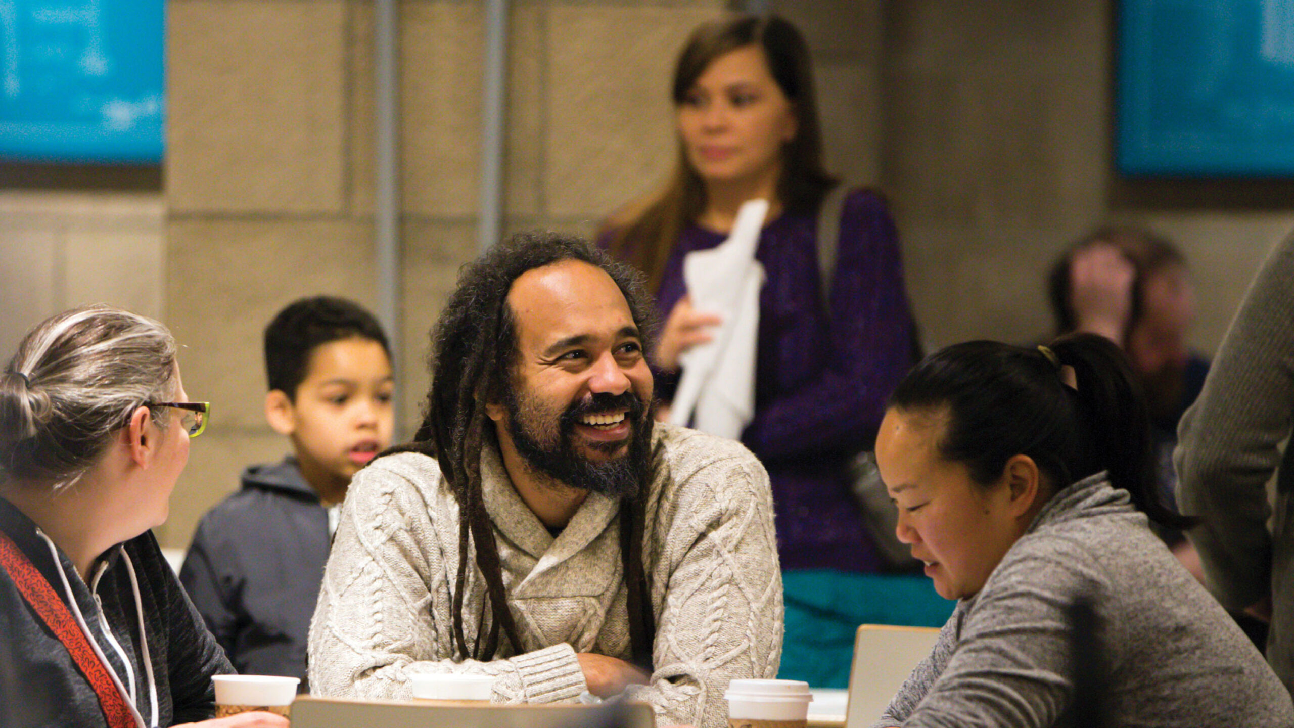 Museum-goers hanging out and smiling at the Walters Cafe